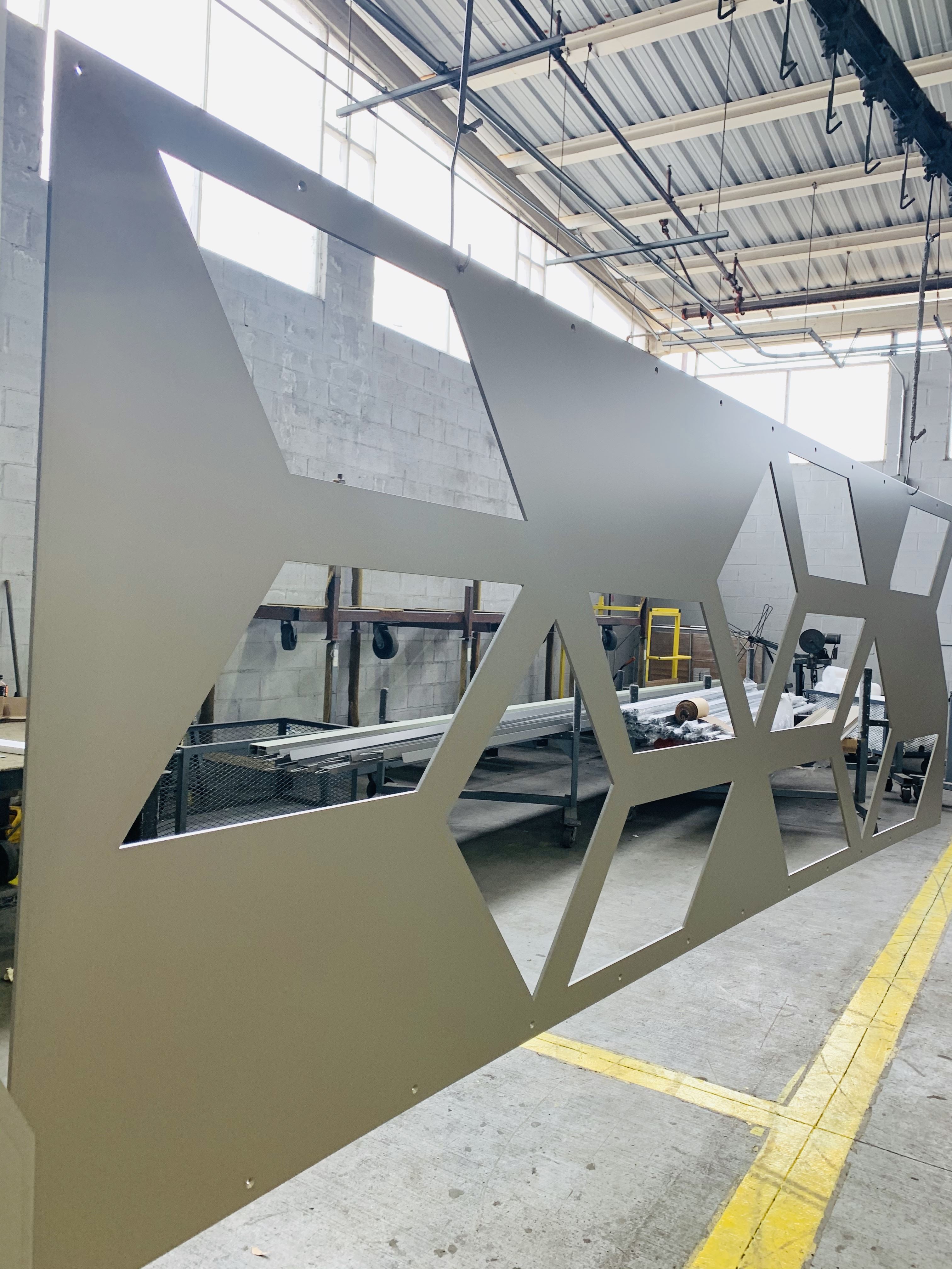 A piece of sheet metal with parallelograms cut into it